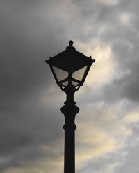 Low angle view of street light against sky at sunset
