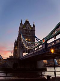 Low angle view of illuminated bridge against sky