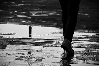 Reflection of people in puddle