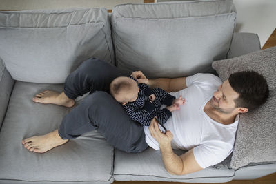 Man with baby on sofa