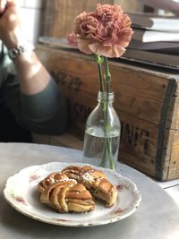 Cropped hand of person preparing food on table