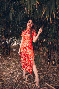 Portrait of a smiling young woman standing outdoors