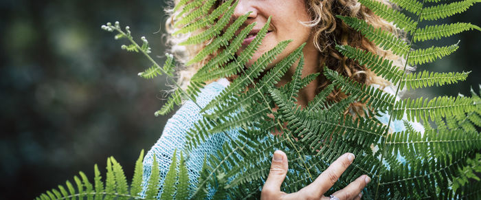 Close-up of woman hand with pine tree