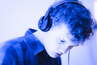 Close-up of young man listening music