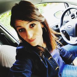 Portrait of woman sitting in car