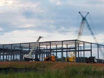 Construction site against cloudy sky