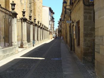 Narrow street amidst buildings in city