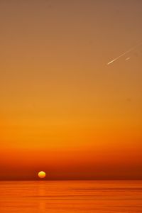 Scenic view of sea against orange sky