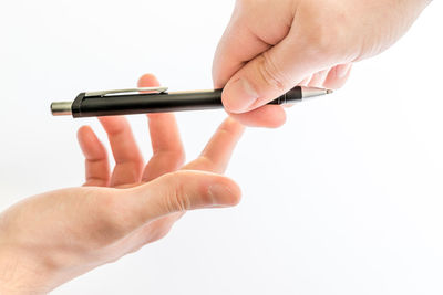 Close-up of man using smart phone against white background