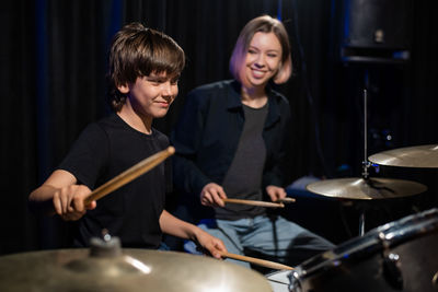 Portrait of smiling young man playing drum