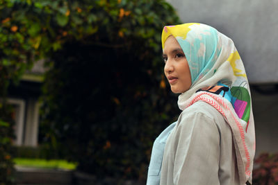 Close-up of woman wearing headscarf while standing outdoors
