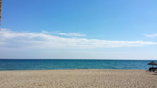 Scenic view of sea against blue sky