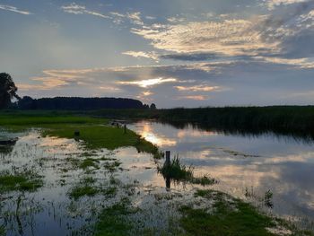 Scenic view of lake against sky during sunset