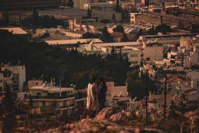 High angle view of woman standing amidst buildings in city