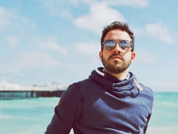 Portrait of man standing against sky