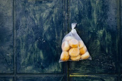 Close-up of bread against wooden wall