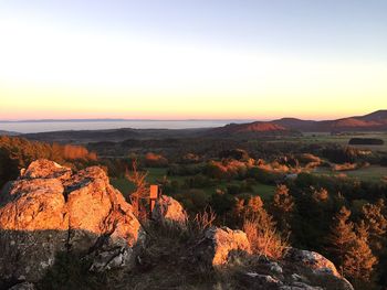 Scenic view of landscape against clear sky during sunset