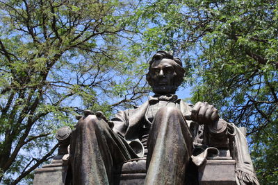 Low angle view of statue against trees