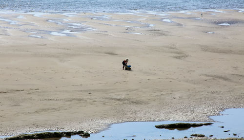 Person standing on sand at beach