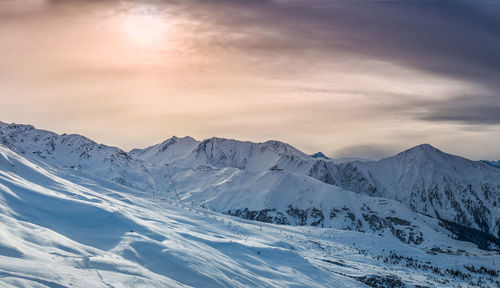 Scenic view of snow covered mountains against sky