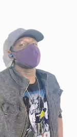 Portrait of young man standing against white background