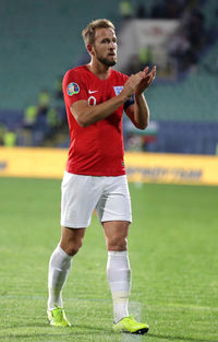 Full length of man standing on soccer field