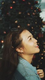 Side view of young woman looking away outdoors