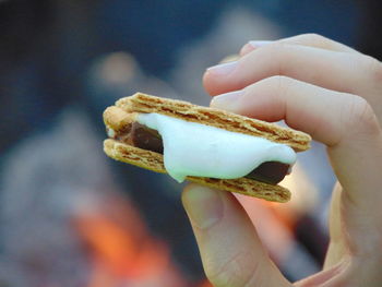 Close-up of human hand holding smore