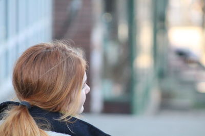 Rear view of young woman with tied hair