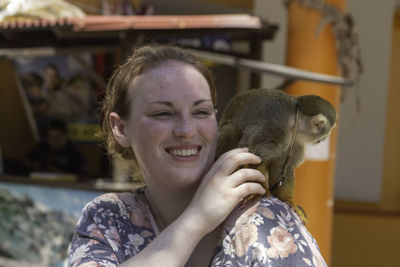 Smiling young woman with monkey