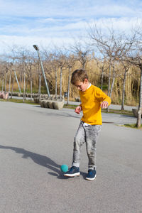 Full length of boy on road