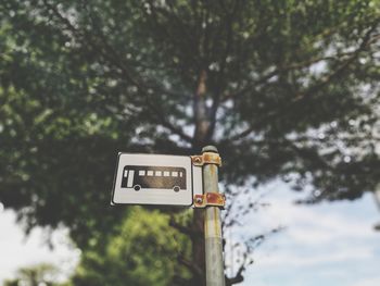 Low angle view of road sign against sky