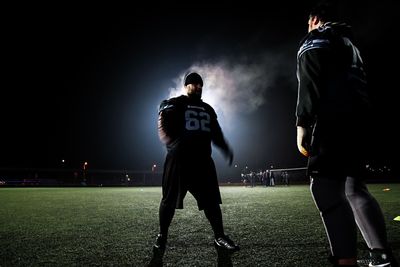 Full length of man standing on grass against sky at night