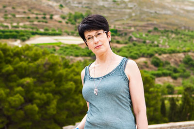 Portrait of smiling young woman standing outdoors