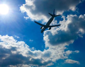 Low angle view of airplane flying in sky