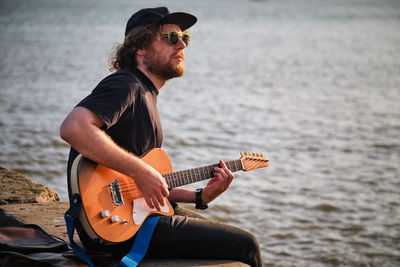 Street musician playing electric guitar in the street