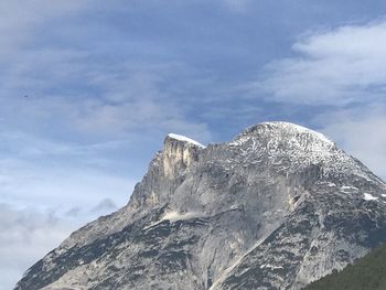 Low angle view of snowcapped mountain against sky