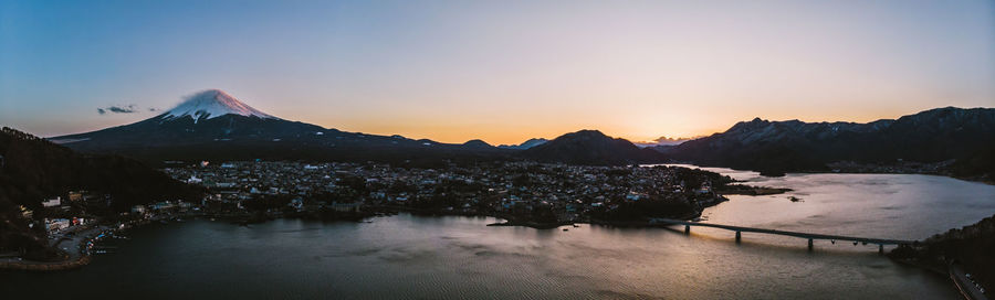 Scenic view of snowcapped mountains against sky during sunset