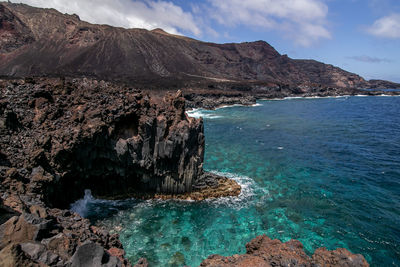 Scenic view of sea and rocks against sky