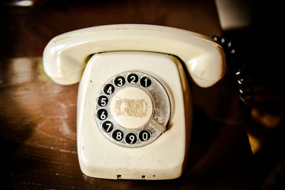 Close-up of old landline telephone on table