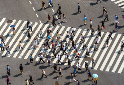 High angle view of people crossing road