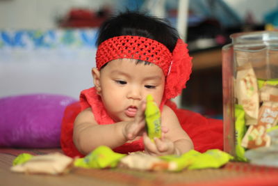 Portrait of cute baby girl looking away