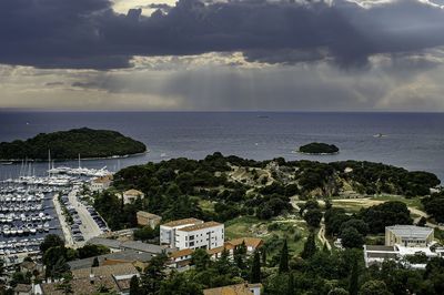 High angle view of townscape by sea against sky