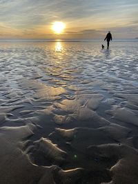 Walking the dog on the beach