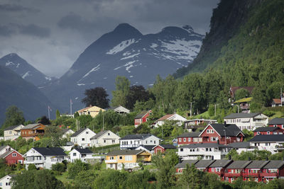 Houses on mountain against sky