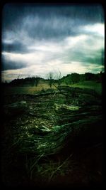 Scenic view of landscape against cloudy sky