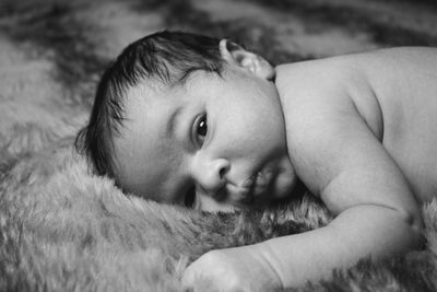 Close-up portrait of cute baby lying down