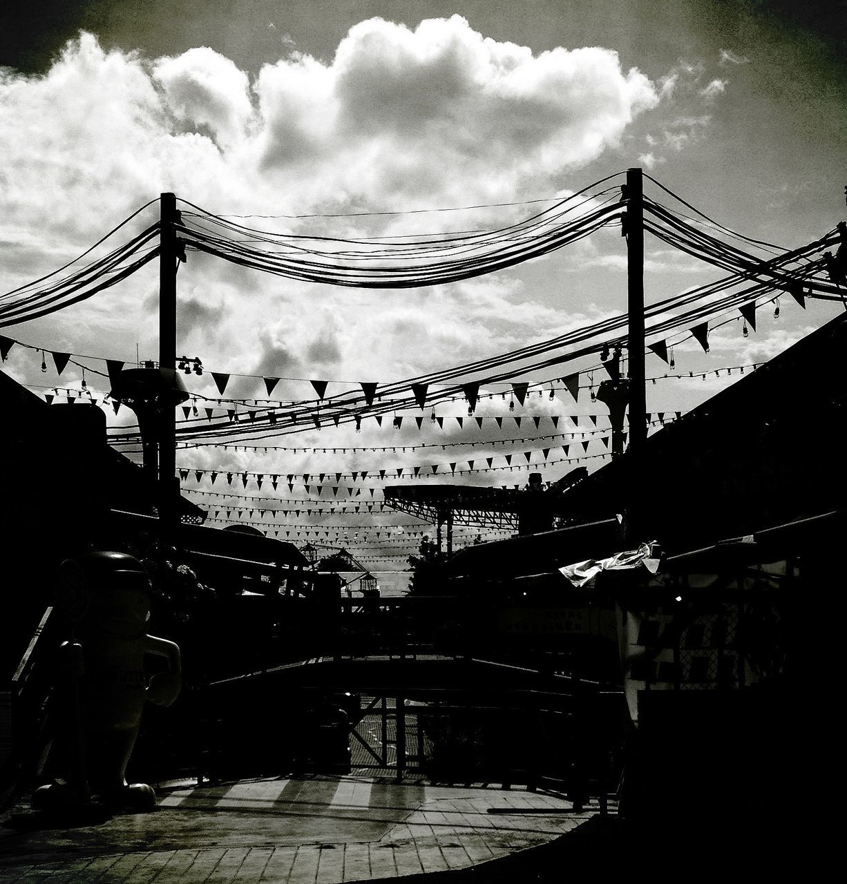 sky, built structure, architecture, cloud - sky, cloudy, low angle view, connection, bridge - man made structure, silhouette, engineering, cloud, metal, travel destinations, dusk, arts culture and entertainment, famous place, amusement park ride, amusement park, ferris wheel, outdoors