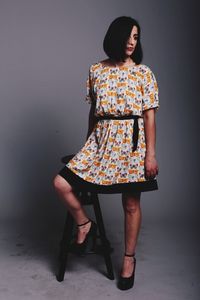 Young woman standing against white background