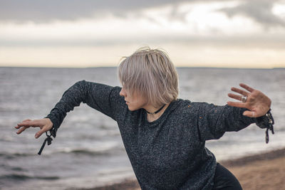 Young woman dancing at beach